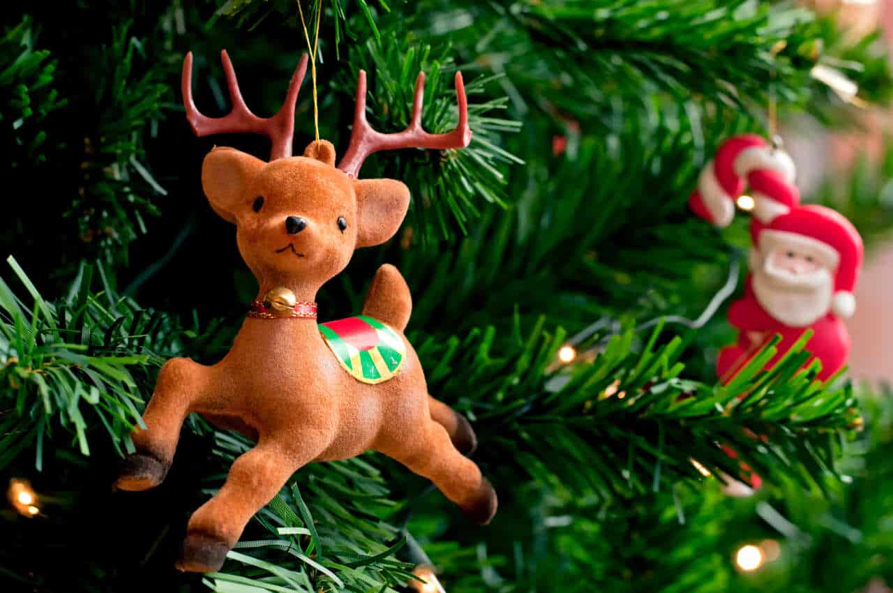 Reindeer and Santa ornaments hanging on Christmas tree