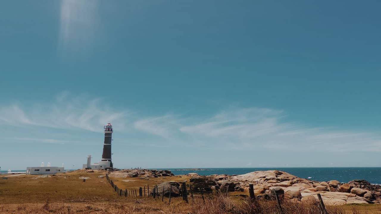 Lighthouse near the sea with clear blue skies