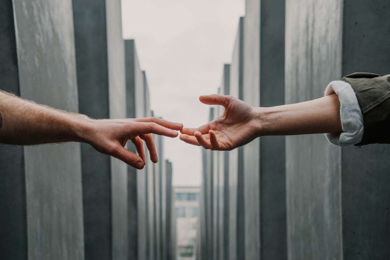 Two hands reaching out towards each other