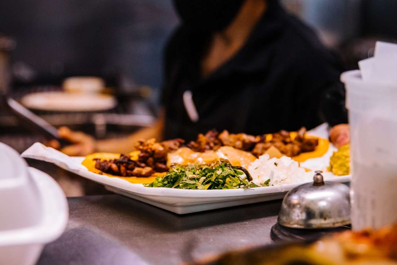 Person serving a plate with mixed food