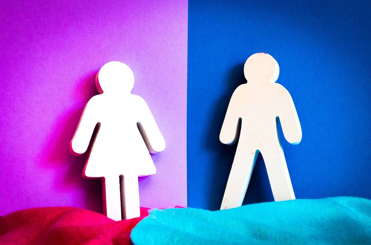 Male and female gender symbols on blue and purple background