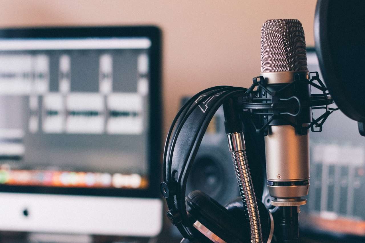 A microphone and headphones placed in front of a computer