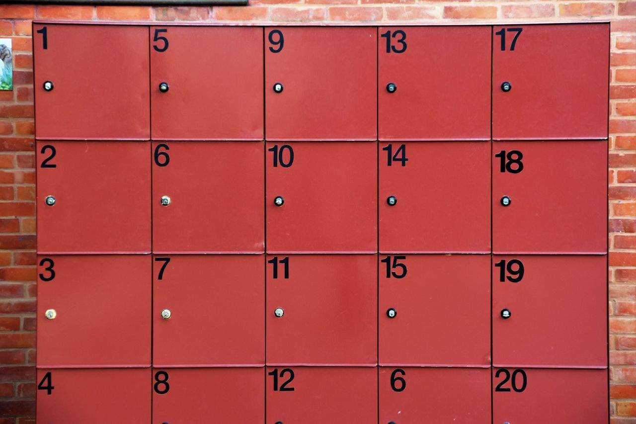 Red locker wall with numbered compartments