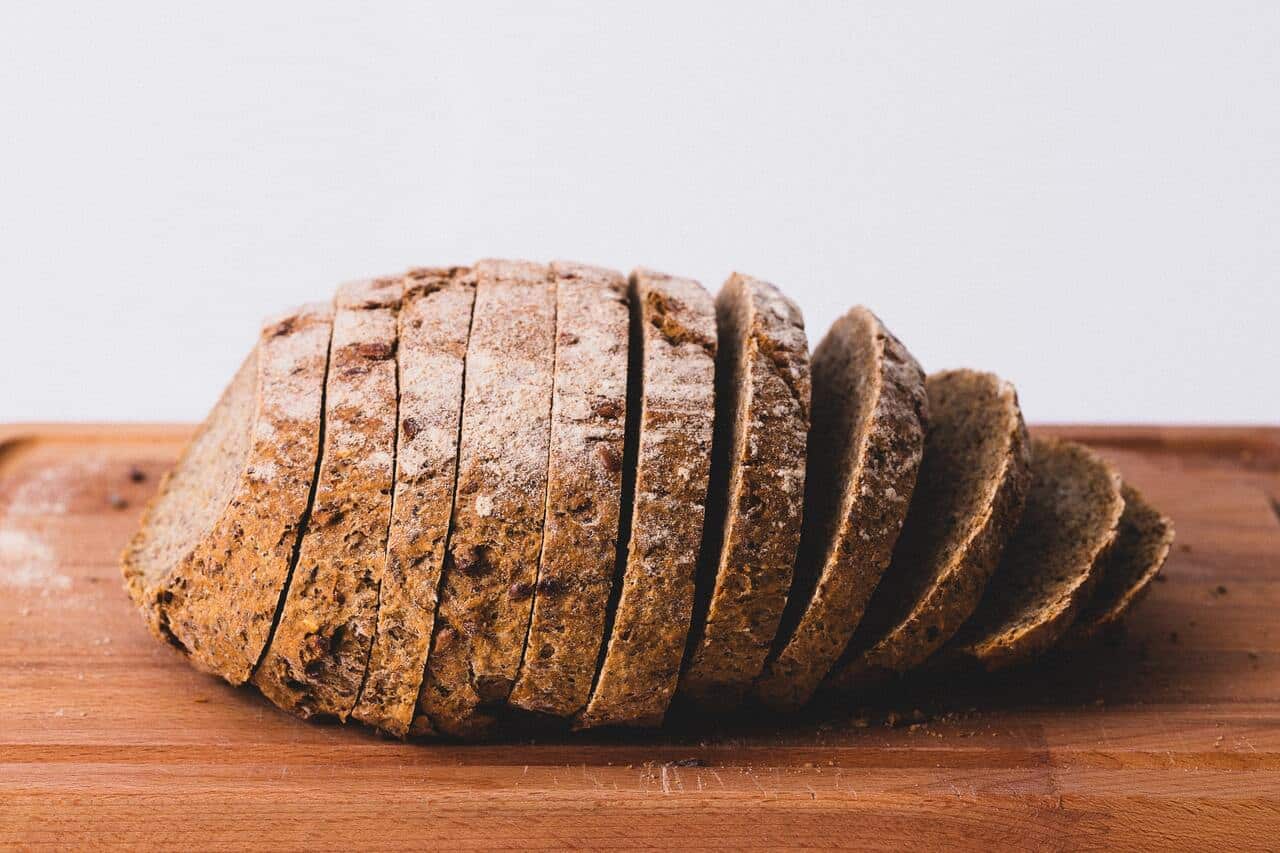 Loaf of sliced bread placed on a wooden surface