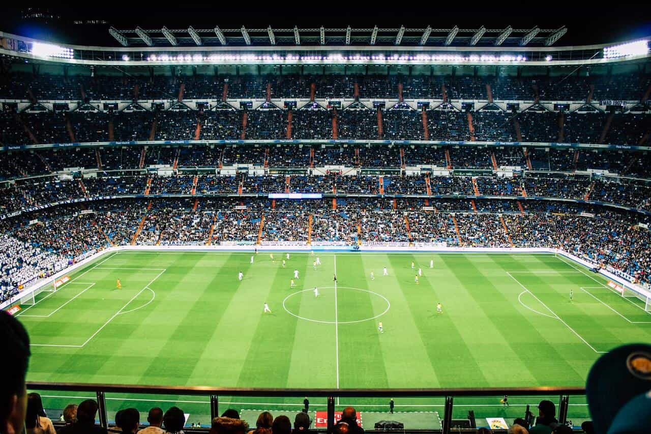 A crowded football stadium with players on the field