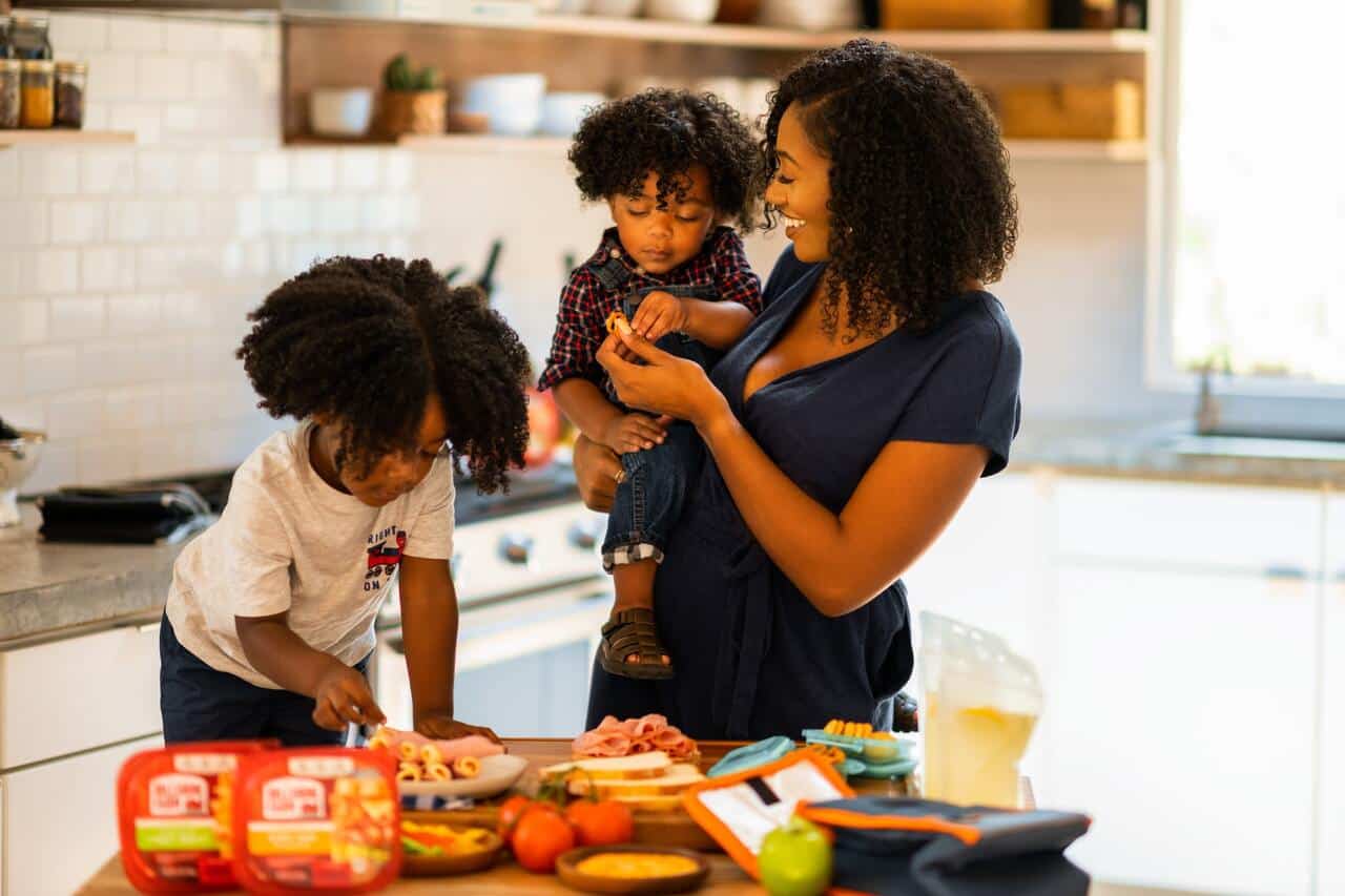 Mother cooking with two children in a modern kitchen