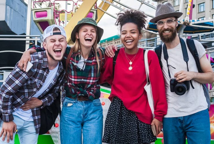 Group of friends laughing together at an outdoor fair