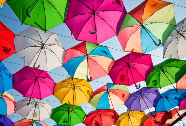 Bright colorful umbrellas hanging in the sky display