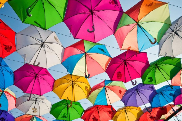 Bright colorful umbrellas hanging in the sky display