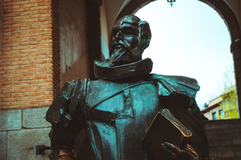 Bronze statue of a man holding a book