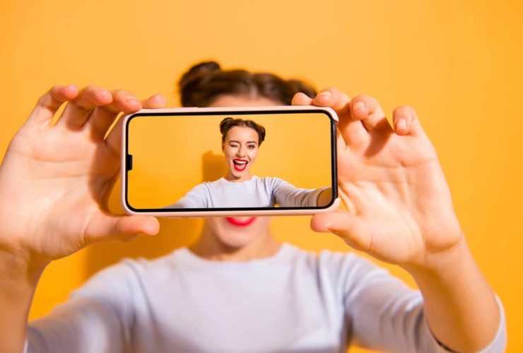 Woman taking a selfie with a winking expression