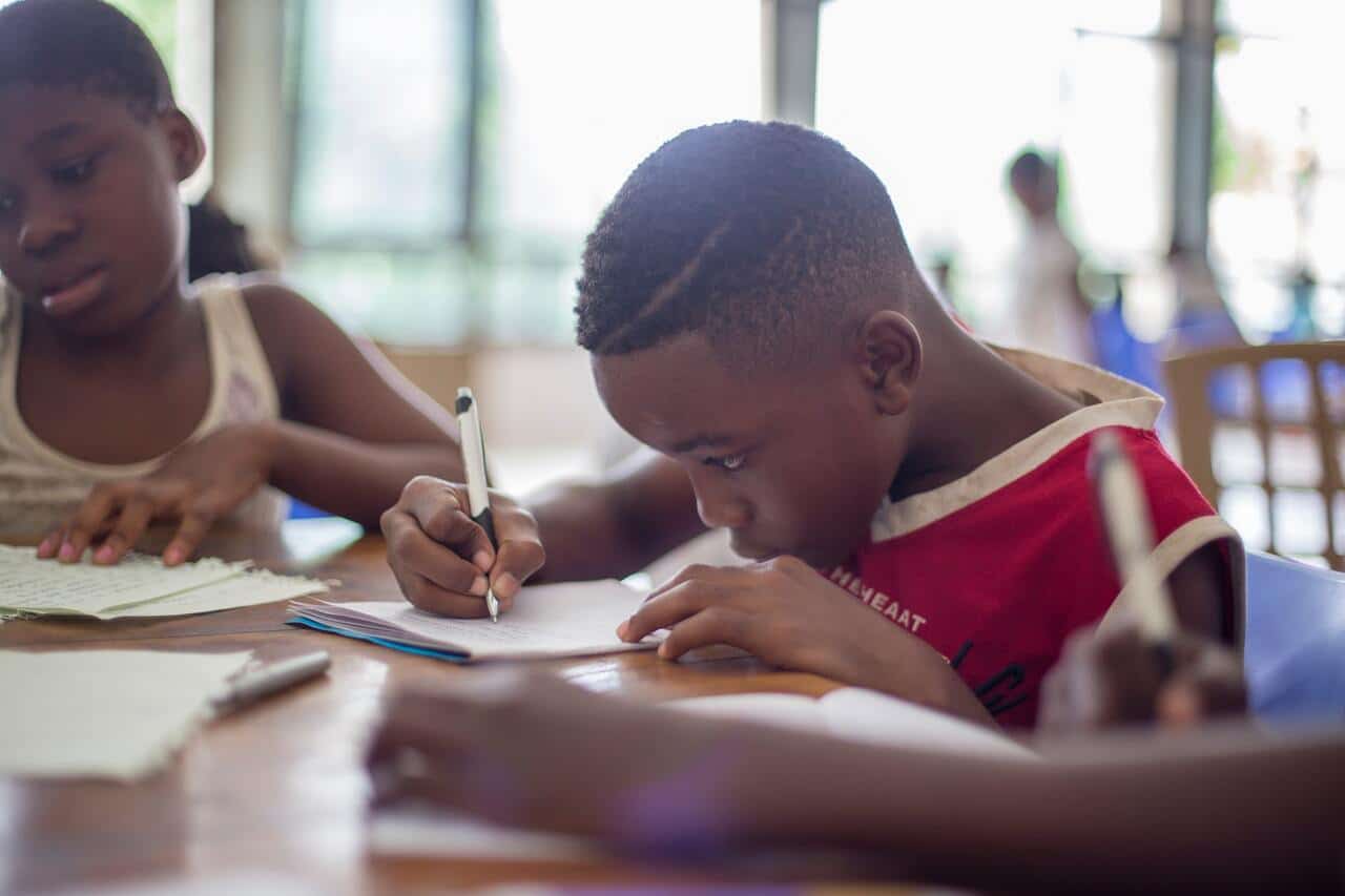 Children focused on writing in a classroom environment