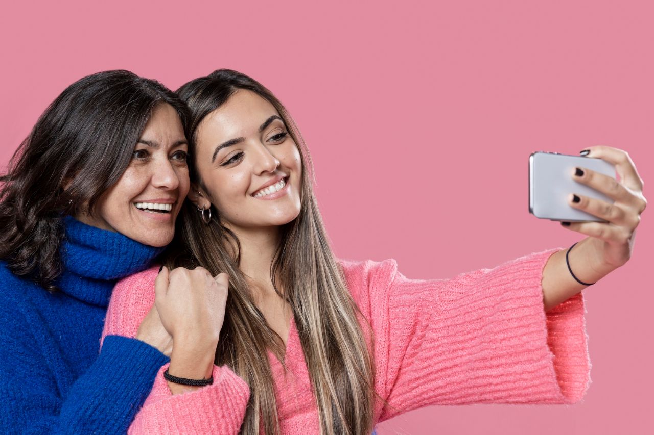 Smiling women taking a selfie together