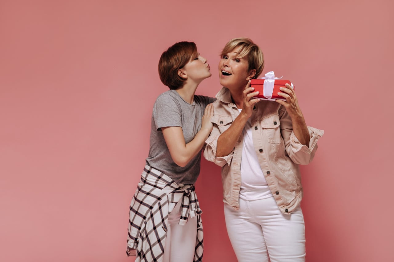 Woman giving a kiss while presenting a gift