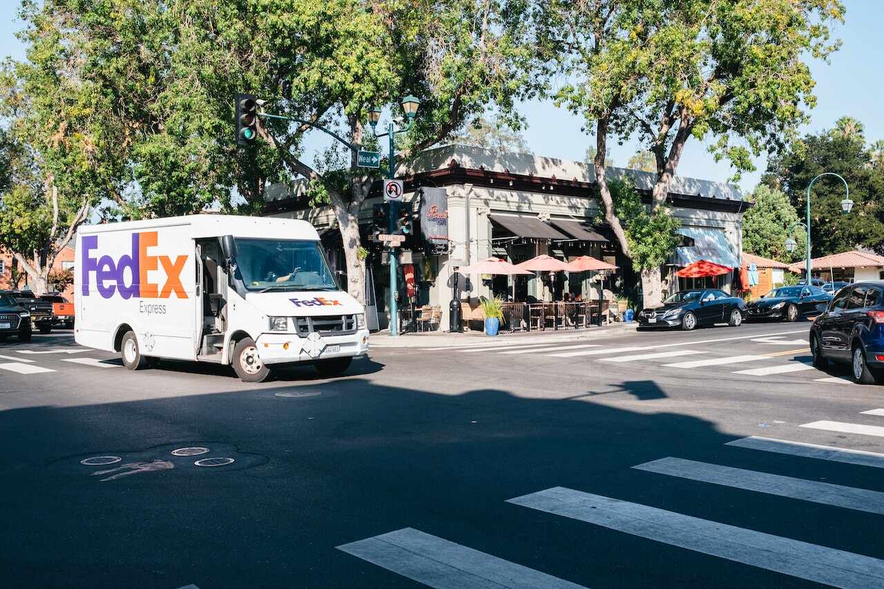 FedEx delivery truck driving through an intersection