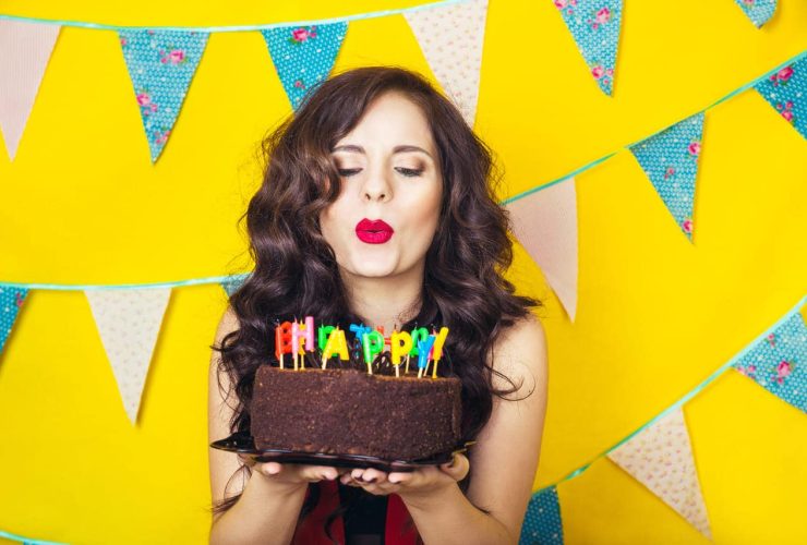 Woman blowing candles on a birthday cake