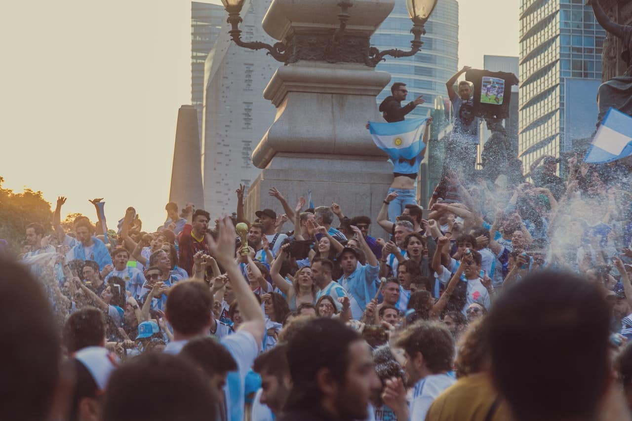 people celebrating with flags and confetti in public