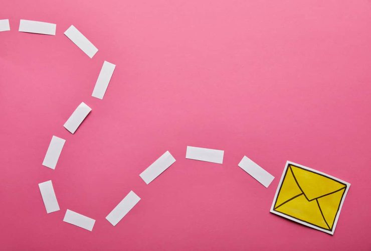 Yellow envelope with white paper trail on pink background.