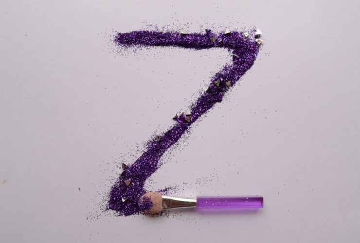 Purple glitter forming the letter "Z" on white background.