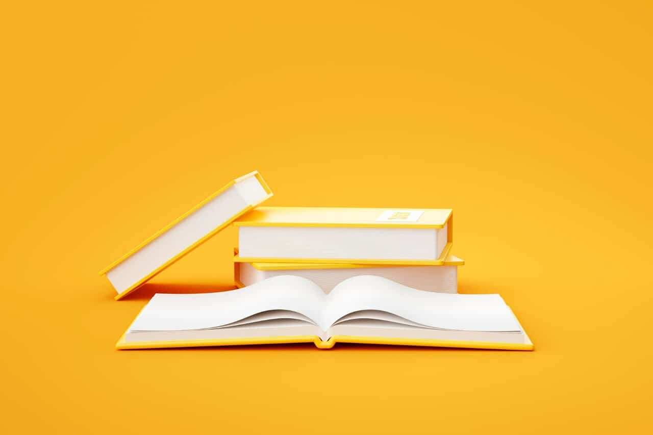 Stack of closed books with one open on a yellow background