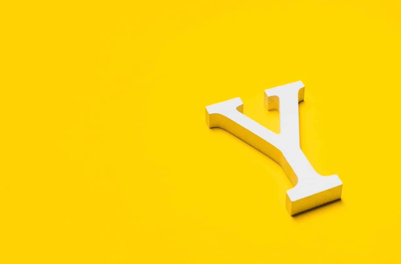 White letter Y on bright yellow background