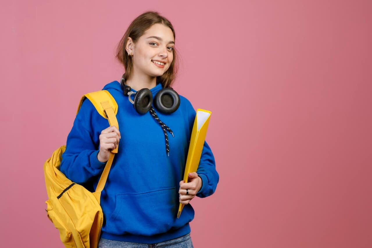 Student in blue hoodie with yellow backpack