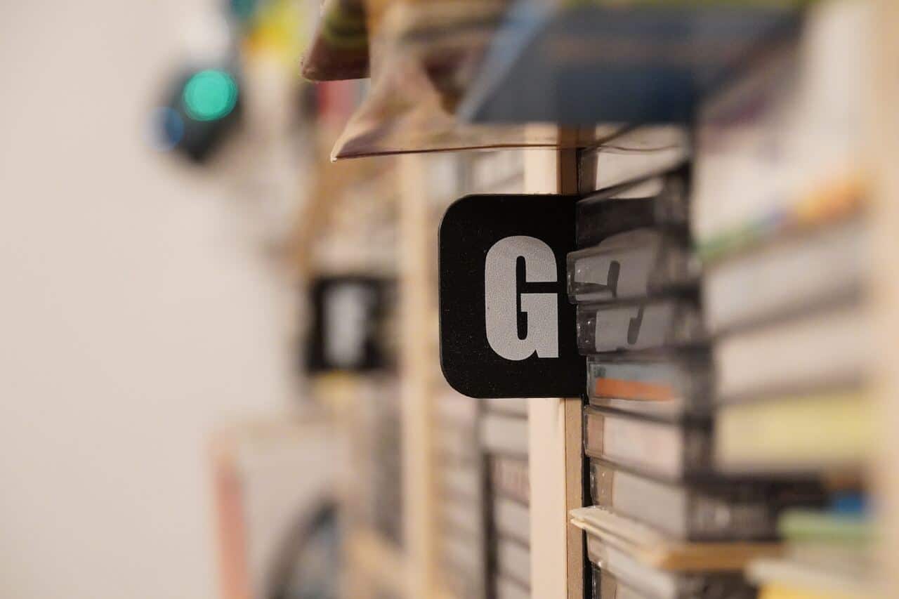 Letter "G" on a black label between books