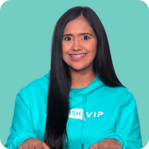 Woman in teal hoodie smiling against light teal background