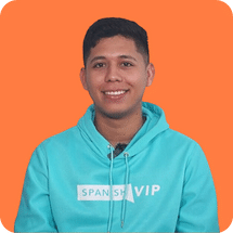 Man in teal hoodie smiling against orange background