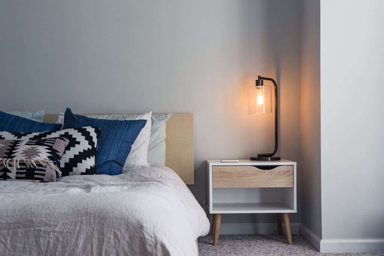 Cozy bedroom with a lit bedside lamp