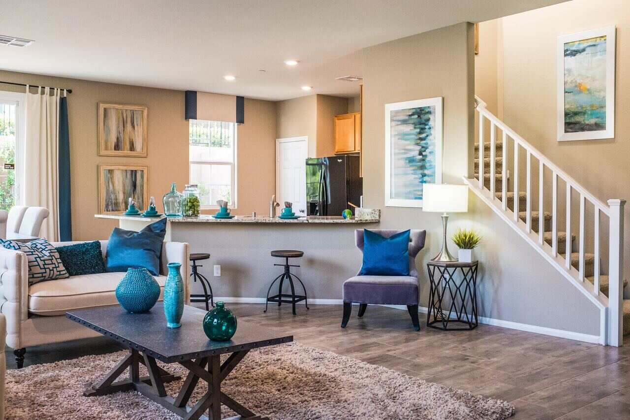 Modern living room with blue decor and open kitchen