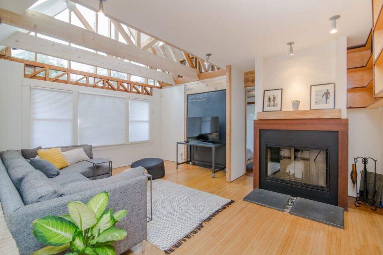 Bright living room with exposed beams and cozy fireplace