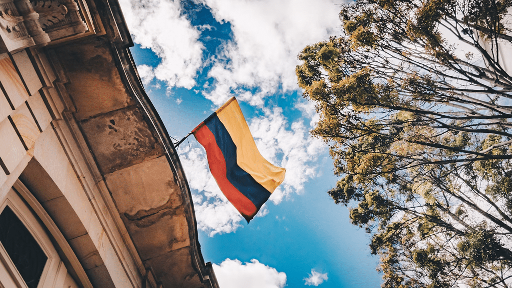 Colombian flag waving on a building rooftop