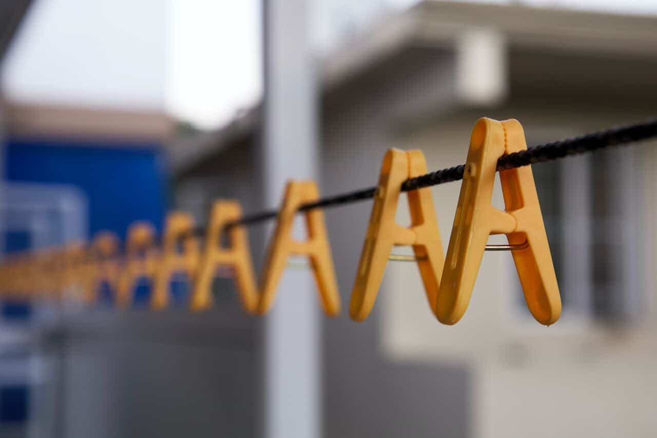 Yellow letter A-shaped clothespins hanging on a clothesline