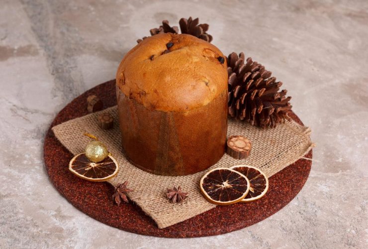 Panettone cake with dried orange slices and pinecones