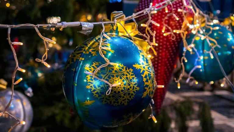 Blue Christmas ornament with yellow snowflake pattern hanging