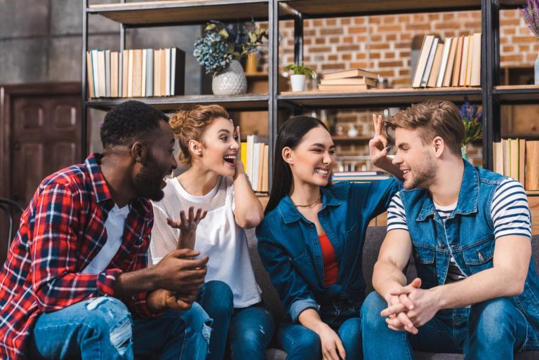 Group of friends laughing and playing a guessing game