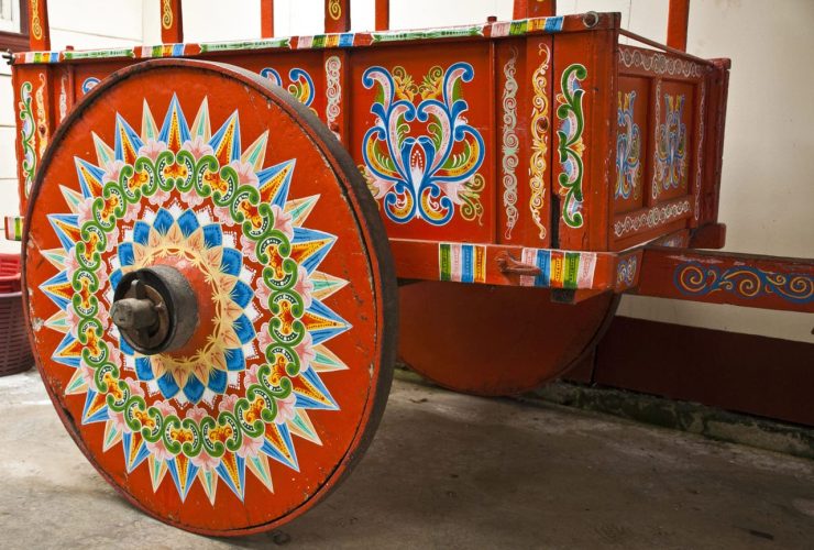 Colorfully painted wooden cart with intricate patterns on its wheel