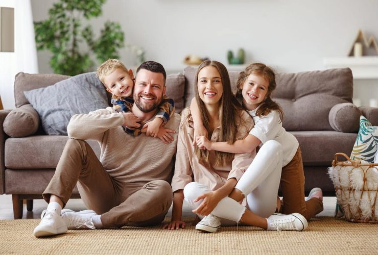 Family sitting together on the living room floor