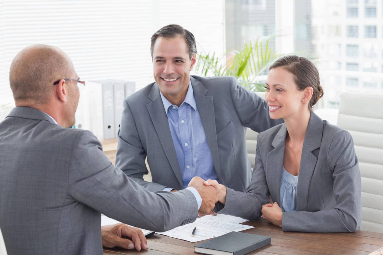 Business professionals shaking hands during a meeting